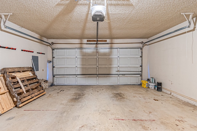 garage with electric panel and a garage door opener