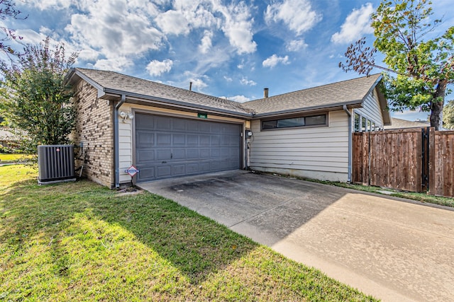 exterior space with central air condition unit, a front yard, and a garage