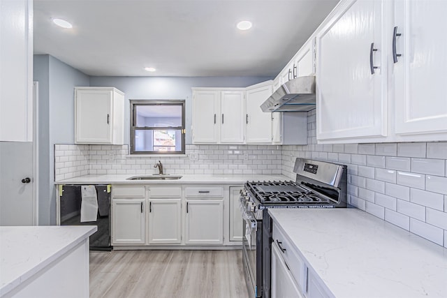 kitchen with dishwasher, stainless steel range with gas cooktop, sink, light wood-type flooring, and white cabinetry