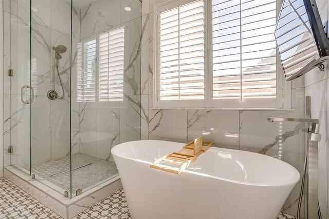 bathroom with separate shower and tub and tile walls