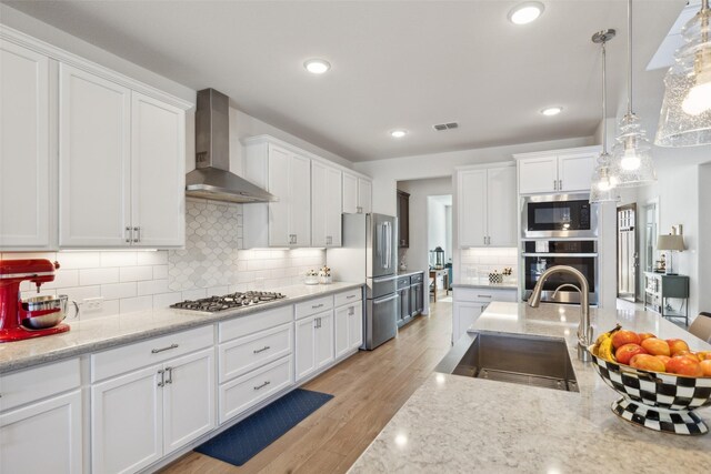 kitchen with dark brown cabinetry, light wood-style flooring, and decorative backsplash