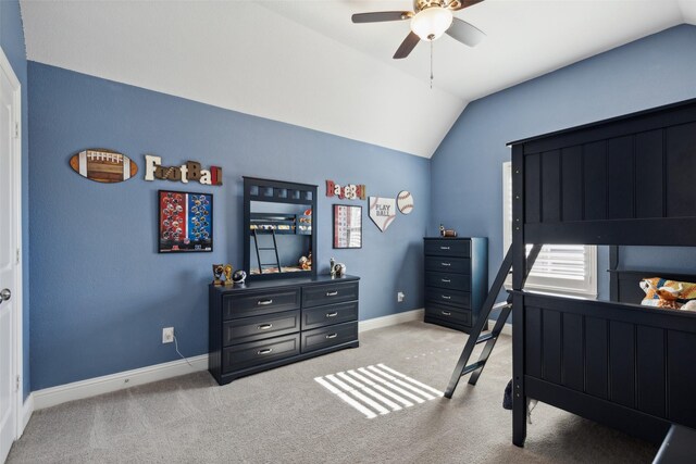 bedroom featuring light carpet, visible vents, baseboards, ensuite bath, and vaulted ceiling