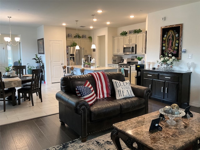 living room featuring dark hardwood / wood-style floors and a notable chandelier