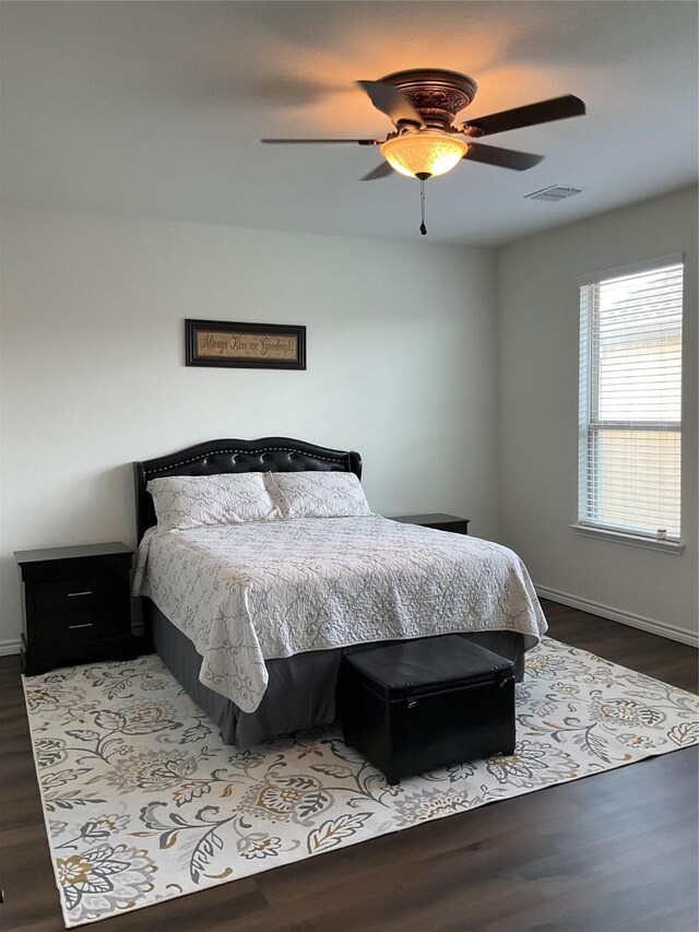 bedroom with ceiling fan and dark hardwood / wood-style floors