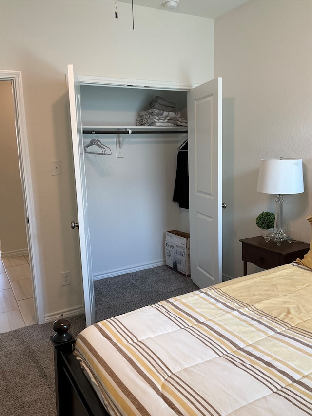 unfurnished bedroom featuring a closet and dark colored carpet