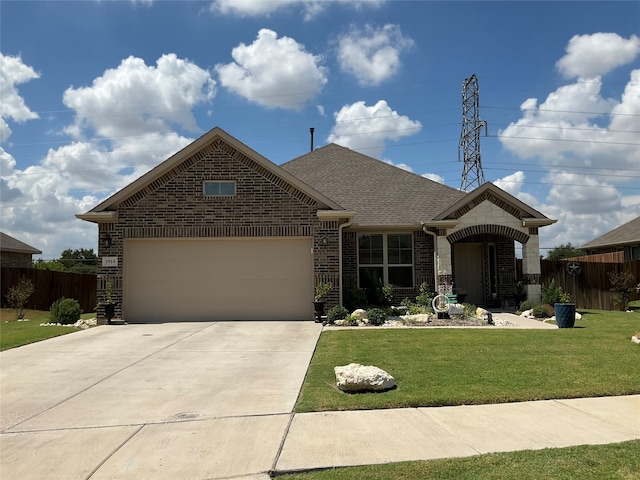 view of front of house with a front yard and a garage