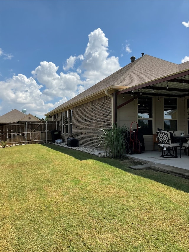 exterior space with a patio area and a yard