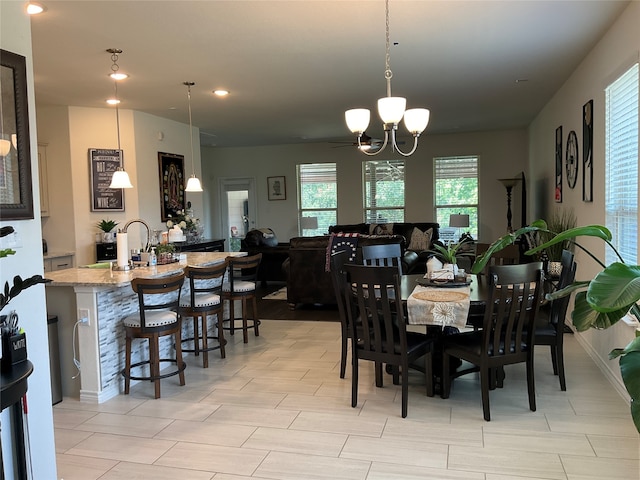 dining space with sink and an inviting chandelier