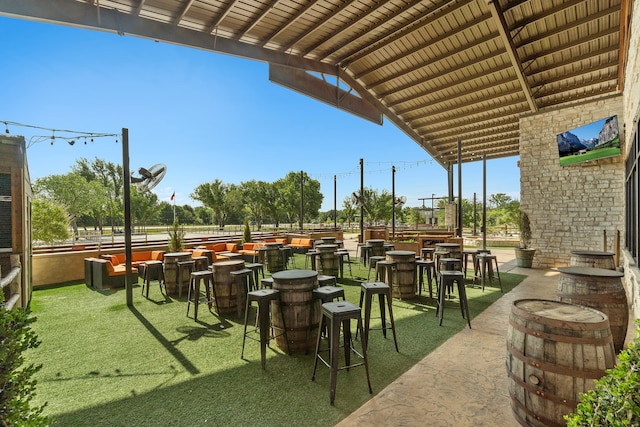 view of property's community with a yard and a patio