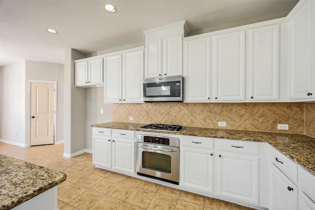 2280 Riviera Dr, Little Elm, TX 75068 - kitchen featuring appliances with stainless steel finishes, light tile patterned flooring, white cabinetry, and recessed lighting