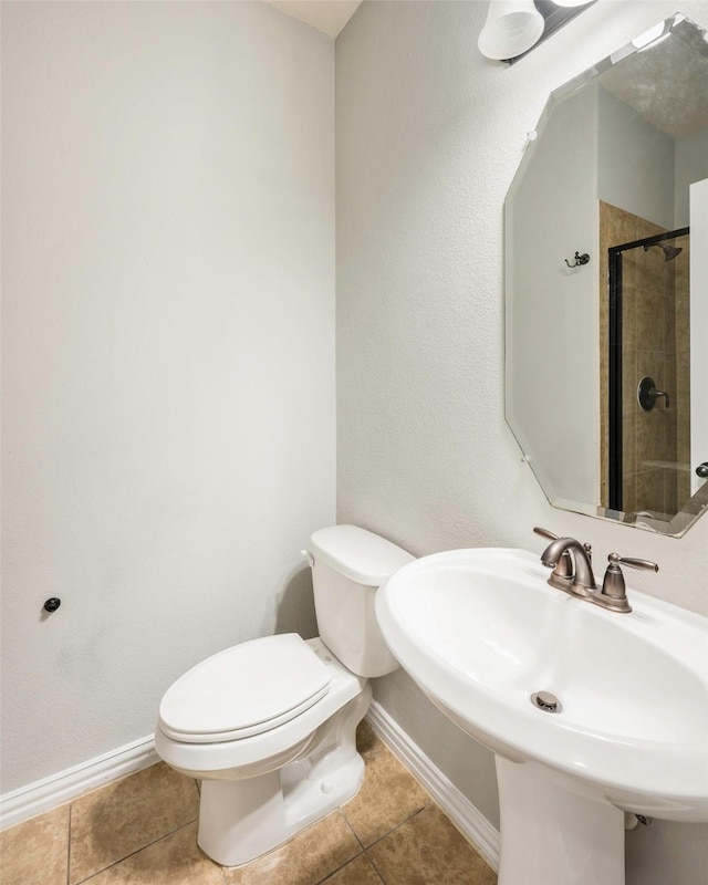 2280 Riviera Dr, Little Elm, TX 75068 - full bath with baseboards, tile patterned flooring, toilet, a sink, and a tile shower