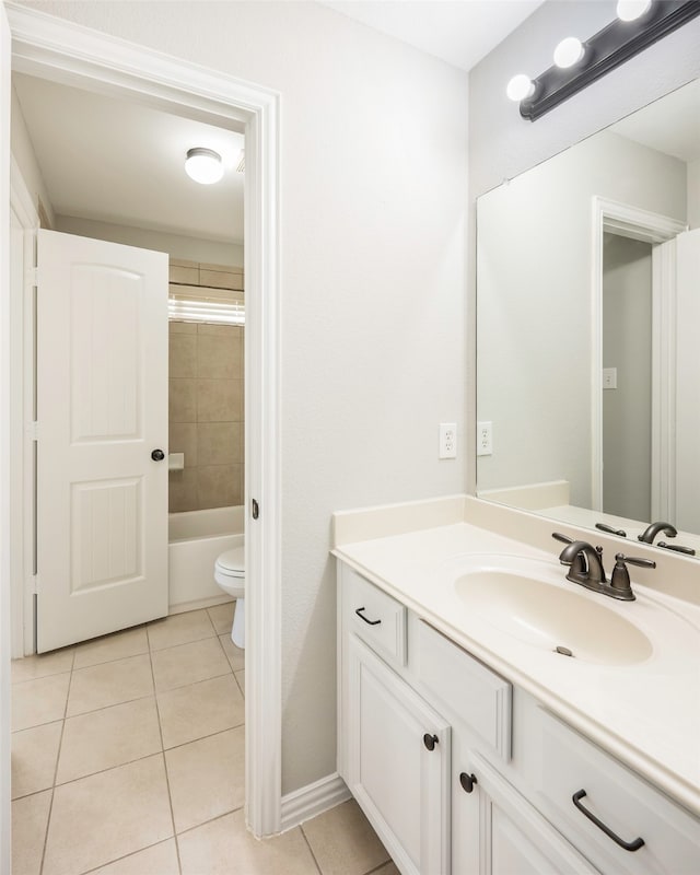 full bathroom featuring tile patterned flooring, vanity, toilet, and tiled shower / bath