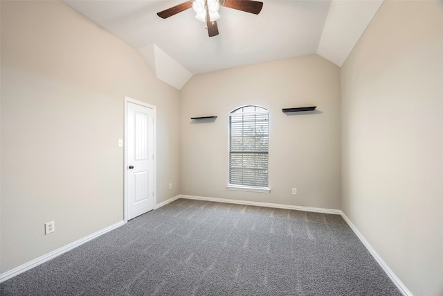 carpeted spare room with ceiling fan and lofted ceiling