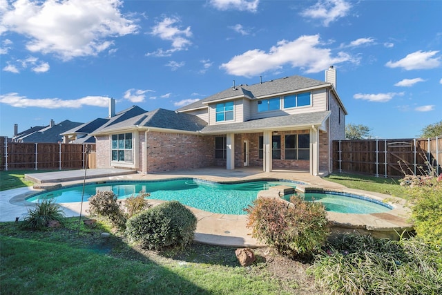 2280 Riviera Dr, Little Elm, TX 75068 - rear view of property featuring an in-ground hot tub, a chimney, brick siding, a fenced backyard, and a patio