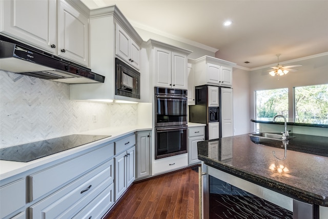 kitchen with sink, wine cooler, white cabinets, black appliances, and ornamental molding