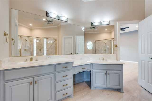 bathroom featuring ceiling fan, crown molding, hardwood / wood-style floors, an enclosed shower, and vanity