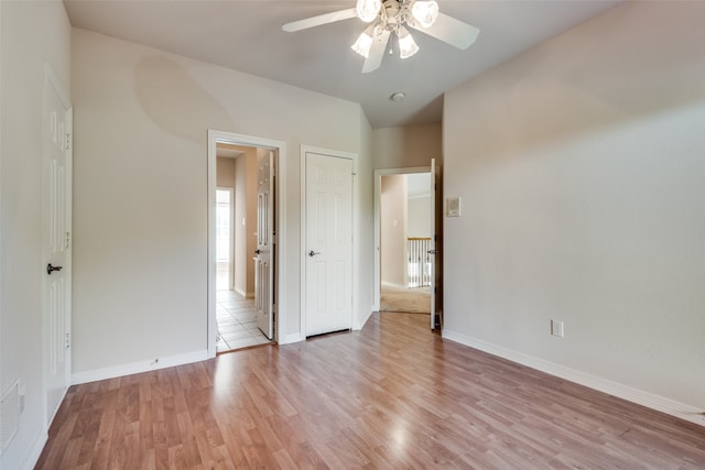 unfurnished bedroom featuring ceiling fan and light hardwood / wood-style floors