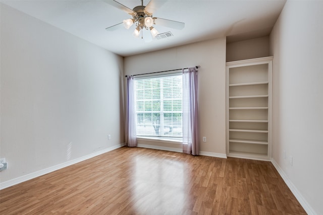 unfurnished room with light wood-type flooring and ceiling fan