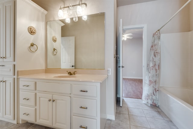 bathroom with tile patterned flooring, ceiling fan, shower / bath combo, and vanity