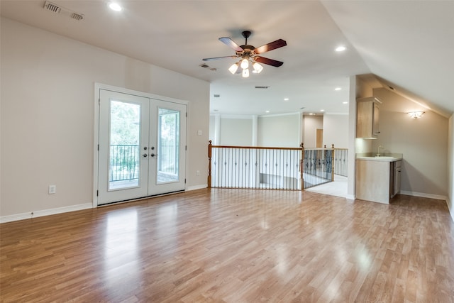 empty room featuring french doors, vaulted ceiling, light hardwood / wood-style flooring, and ceiling fan