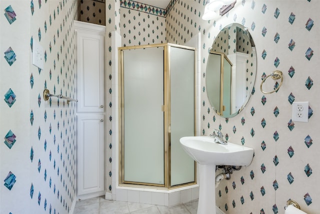 bathroom featuring tile patterned floors and a shower with shower door