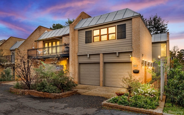 view of front of house featuring a balcony and a garage