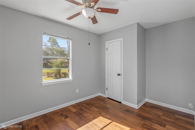 unfurnished room featuring dark hardwood / wood-style floors and ceiling fan