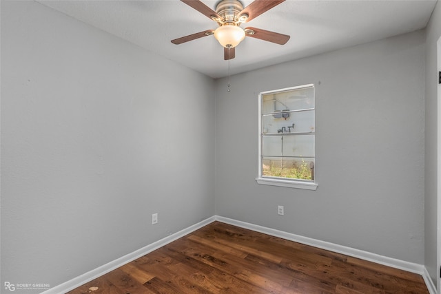 unfurnished room featuring dark wood-type flooring and ceiling fan