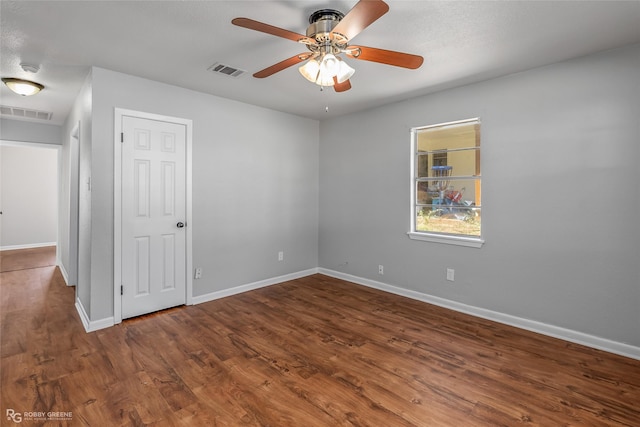 unfurnished room featuring ceiling fan and dark hardwood / wood-style flooring