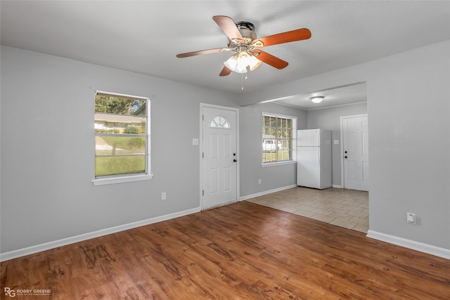 entrance foyer with ceiling fan and light hardwood / wood-style flooring