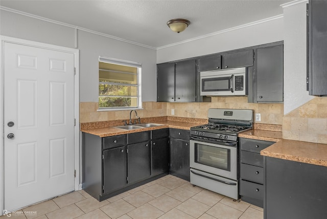 kitchen featuring sink, decorative backsplash, ornamental molding, a textured ceiling, and appliances with stainless steel finishes