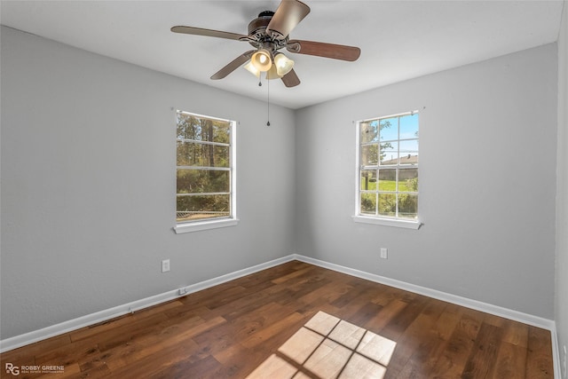 unfurnished room featuring ceiling fan and dark wood-type flooring