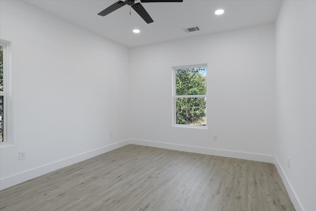 spare room featuring ceiling fan and light hardwood / wood-style flooring