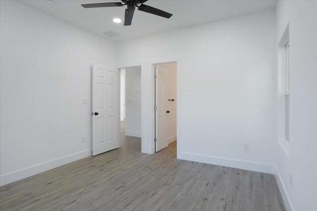 empty room featuring ceiling fan and light hardwood / wood-style floors