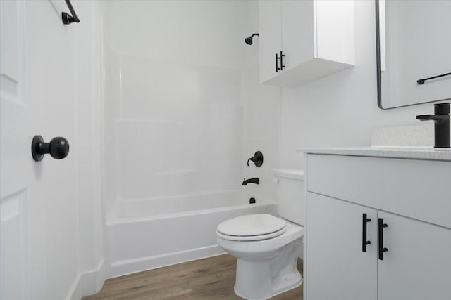 full bathroom featuring wood-type flooring, vanity, toilet, and tub / shower combination