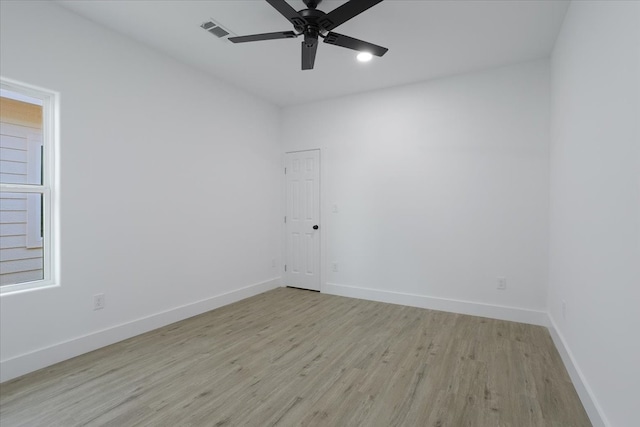 spare room featuring ceiling fan and light hardwood / wood-style flooring