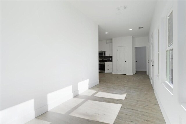 hallway with light hardwood / wood-style flooring