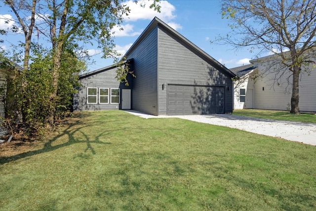 view of home's exterior with a yard and a garage