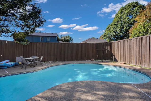 view of swimming pool with a fenced in pool, a fenced backyard, and a patio area