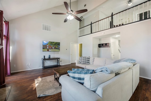 living room with dark hardwood / wood-style floors, ceiling fan, and high vaulted ceiling