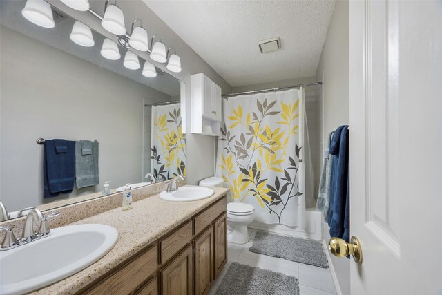 full bathroom with shower / bath combination with curtain, a textured ceiling, vanity, tile patterned flooring, and toilet