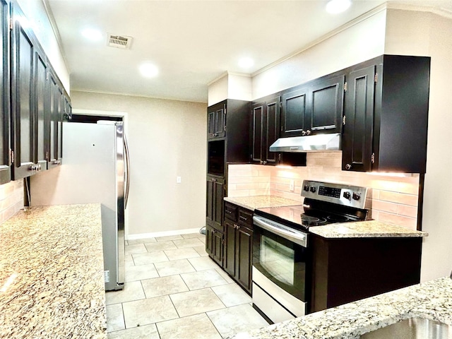 kitchen featuring backsplash, light stone counters, and stainless steel appliances