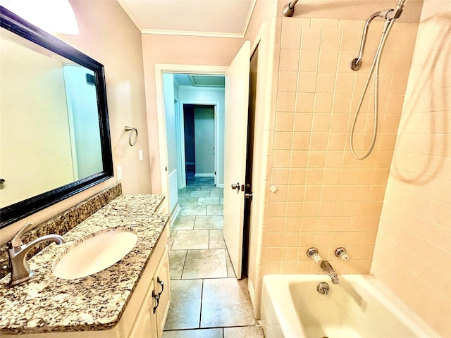 bathroom featuring vanity, ornamental molding, and tiled shower / bath