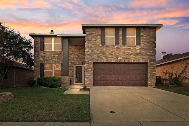 front of property with a garage and a yard