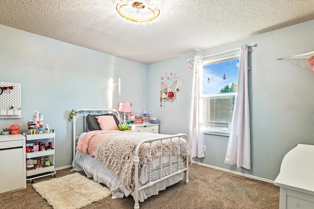 bedroom featuring carpet and a textured ceiling