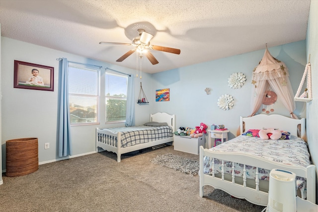 carpeted bedroom with ceiling fan and a textured ceiling