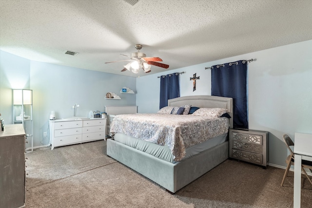 carpeted bedroom featuring ceiling fan and a textured ceiling