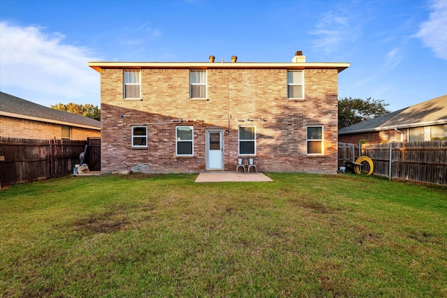 rear view of property featuring a patio and a yard