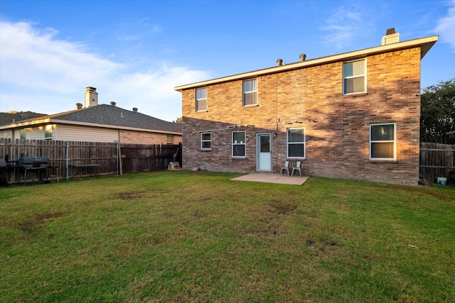 back of property featuring a patio area and a lawn