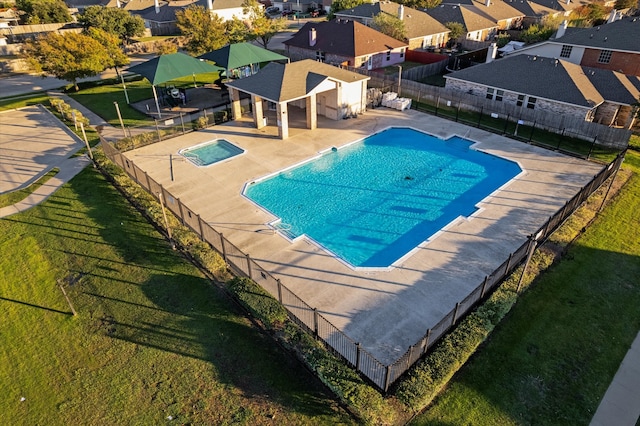 view of swimming pool featuring a patio and a lawn